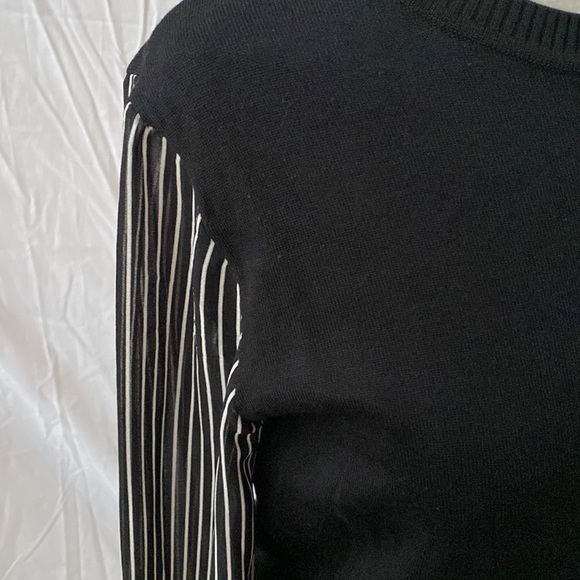 Black sweater with black and white striped sleeves. Great condition. - Picture 2 of 7